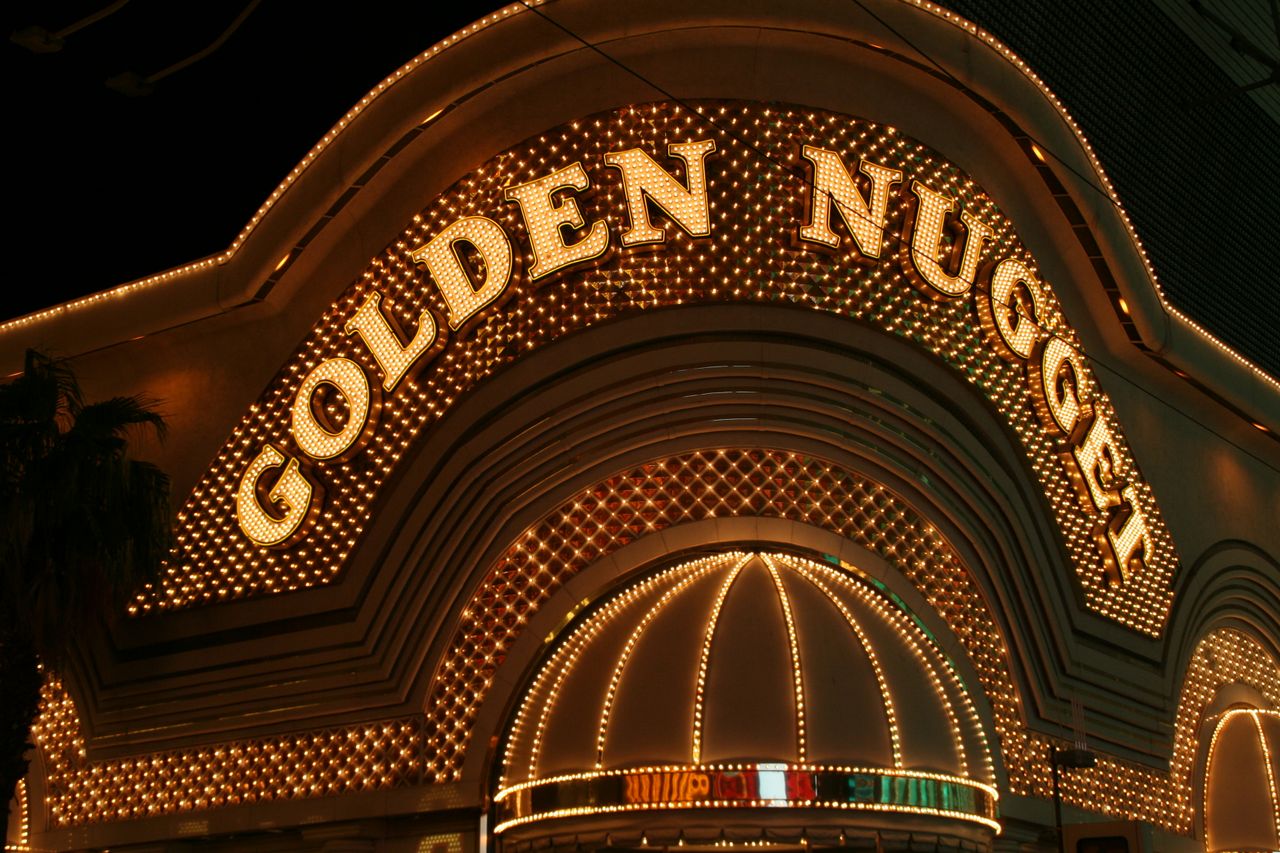 Iconic Golden Nugget casino entrance with bright lights at night in Las Vegas.